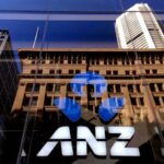 FILE PHOTO: The logo of the ANZ Banking Group is displayed in the window of a newly opened branch in central Sydney, Australia