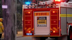 Fire truck advertising a reward for arson information.
