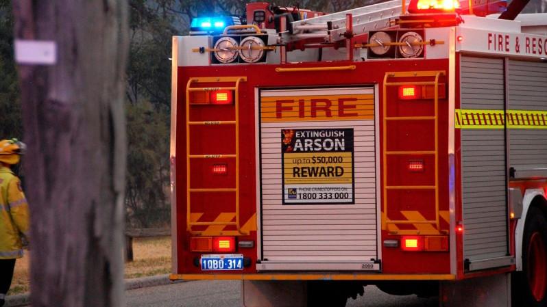 Fire truck advertising a reward for arson information.