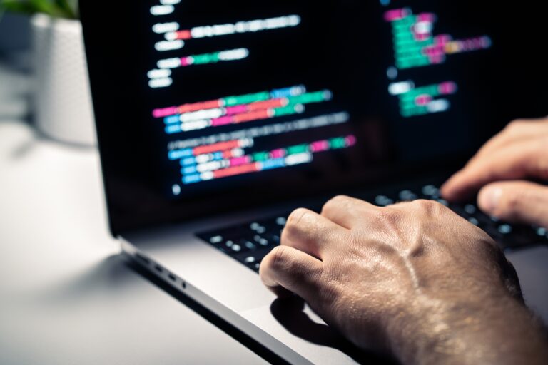 Hacker,With,Malware,Code,In,Computer,Screen.,Cybersecurity,,Privacy,Or