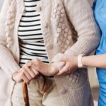 Gentle trained nurse helping mature patient