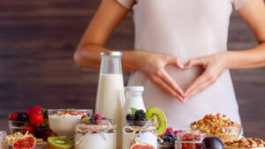 Female make shape of heart with her hands. Light summer breakfas