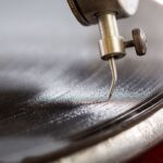 Closeup shot of a needle of the gramophone with a shellac disk