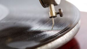 Closeup shot of a needle of the gramophone with a shellac disk