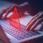 System hacked warning alert on notebook (Laptop). Cyber attack on computer network, Virus, Spyware, Malware or Malicious software. Cyber security and cybercrime. Compromised information internet.