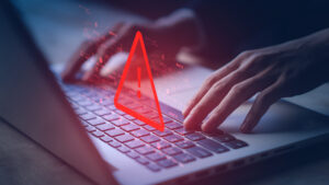 System hacked warning alert on notebook (Laptop). Cyber attack on computer network, Virus, Spyware, Malware or Malicious software. Cyber security and cybercrime. Compromised information internet.