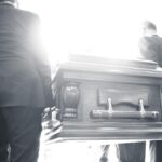 Rear View Of People Carrying Coffin