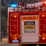 Fire truck advertising a reward for arson information.