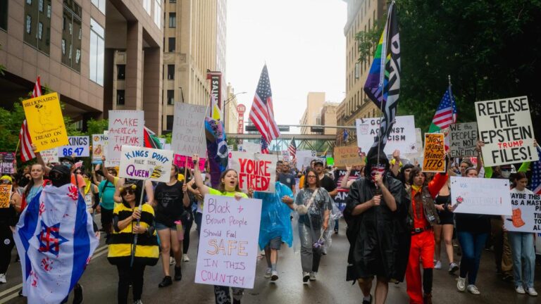 Demonstrators march through the streets of downtown despite heavy rain for the No Kings Day protests in Dallas, Texas on Saturday, Oct. 18, 2025. (Desiree Rios/The New York Times)