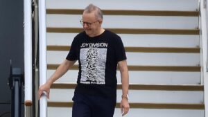 EXCLUSIVE Jet Lag & Joy Division for Albo! Australia’s Prime Minister returned home post-Trump looking more rock ’n’ roll than political — swapping power suits for post-punk style on the tarmac.