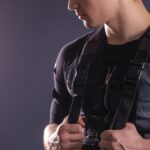 portrait of handsome man near electro muscle stimulation machine