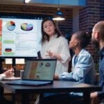 Business analytics team meeting, woman showing corporate presentation