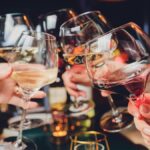 Clinking glasses with alcohol and toasting, party.