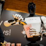 tesla-s-optimus-robot-dazzles-berlin-hands-out-popcorn-today-