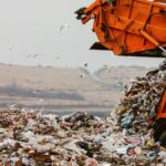Garbage truck dumping the garbage on a landfill