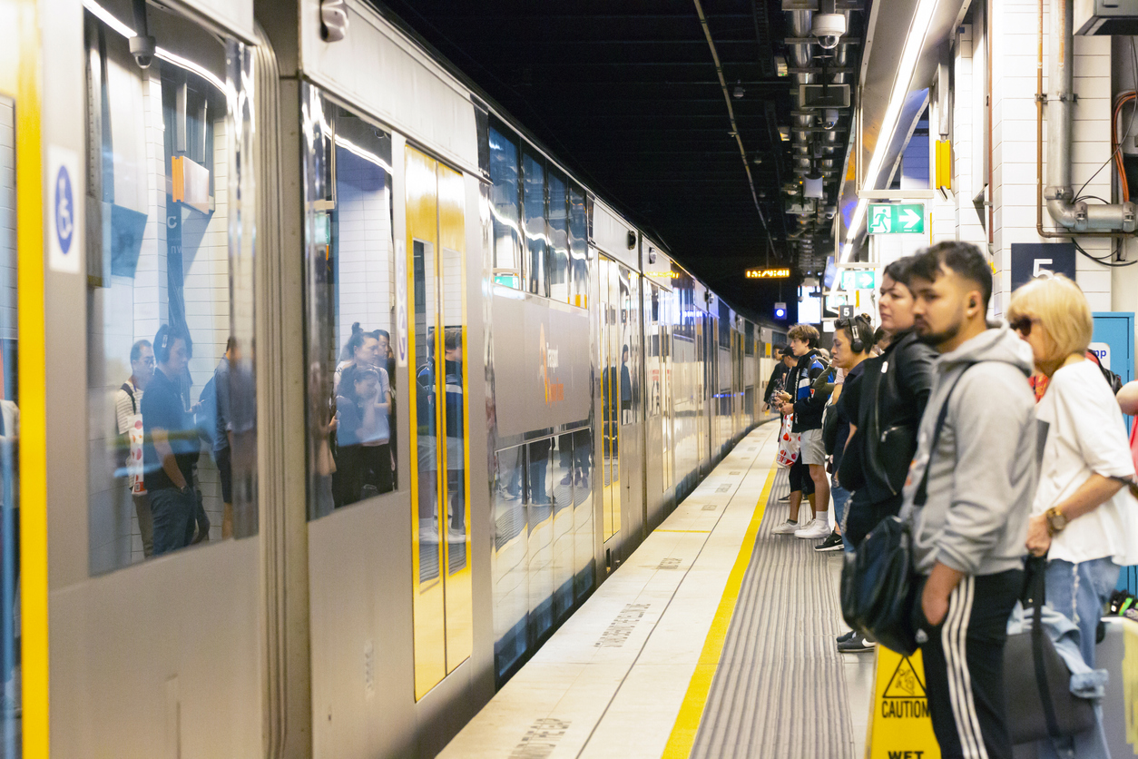 People waiting for arrival of train in subway station