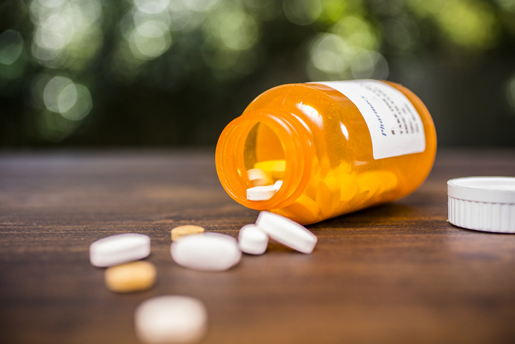 Prescription pill bottle, medicine tablets in pharmacy.